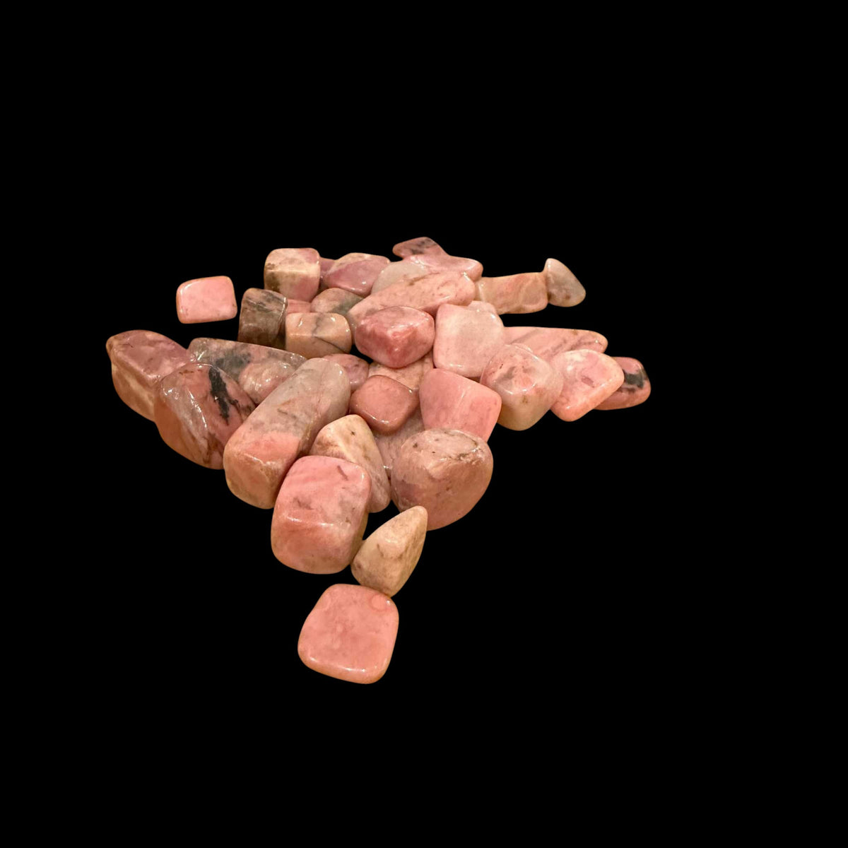 Pile of pink stones on a black background