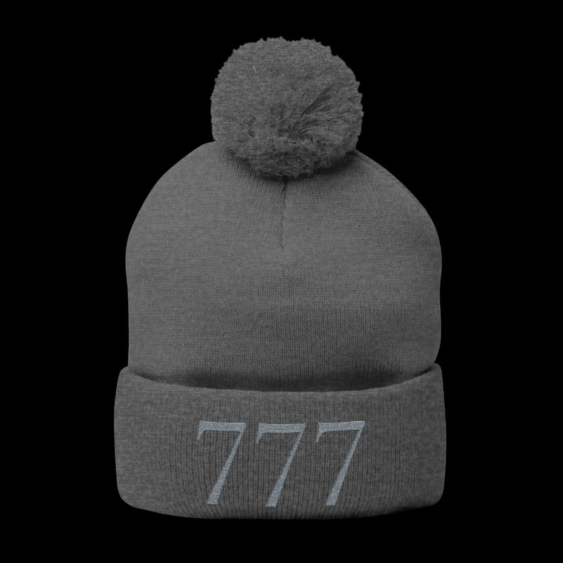 Gray beanie with pom-pom and '777' logo on a white background