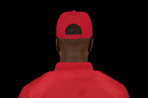Person wearing a red cap from behind on a white background