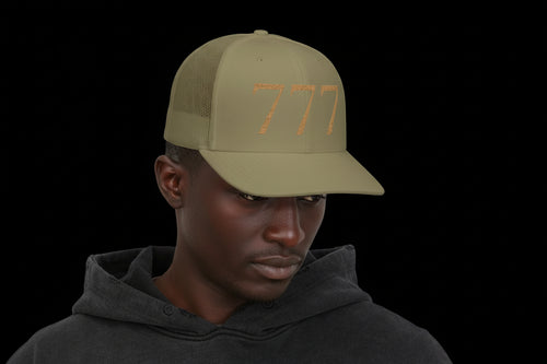 Man wearing a green cap with a logo on a white background