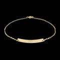 Gold bracelet with a bar for engraving on a white background