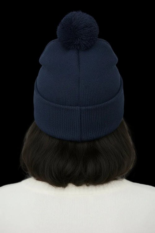 Black beanie with pom-pom on a white background