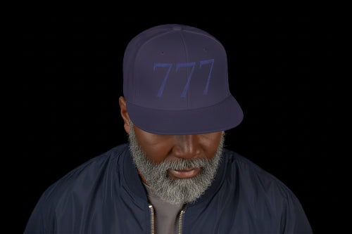 Man wearing a dark purple cap with a logo on a white background