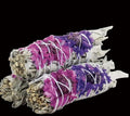 Two bundles of purple and white sage smudge sticks with an USDA Organic label on a white background.