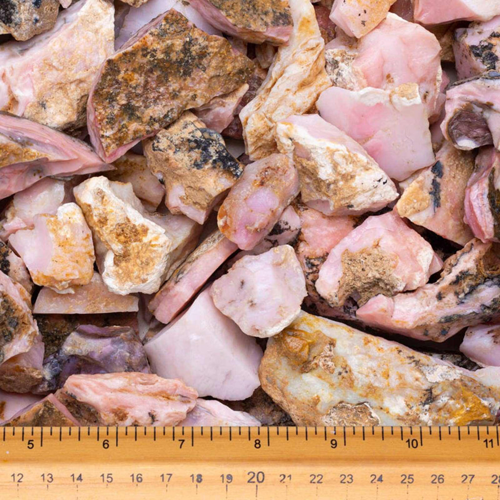 Assorted pink and brown rocks with a ruler at the bottom for scale.