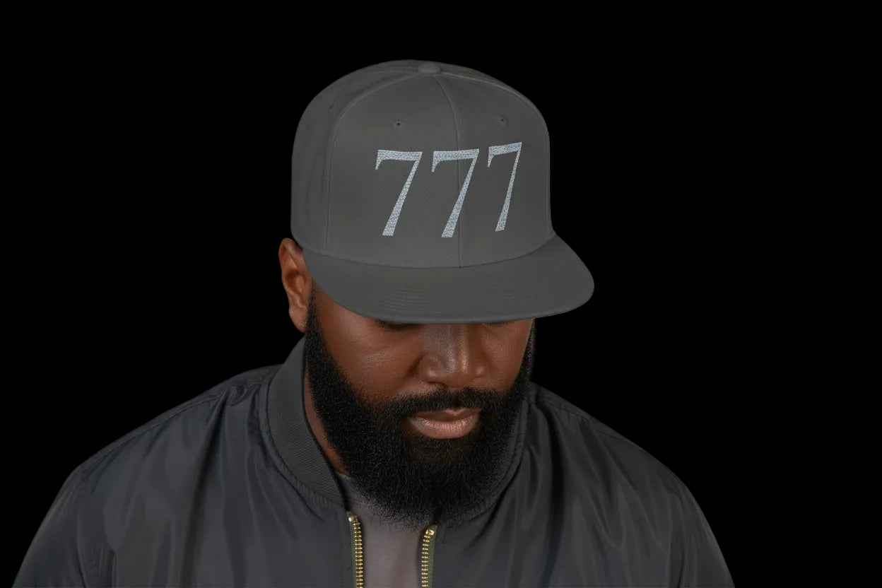 Person wearing a dark gray cap with '777' on a white background