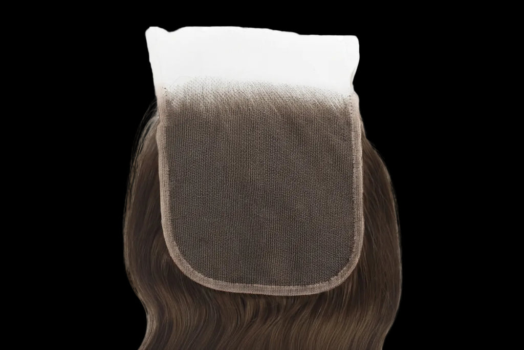 Brown hairpiece with a mesh back on a white background