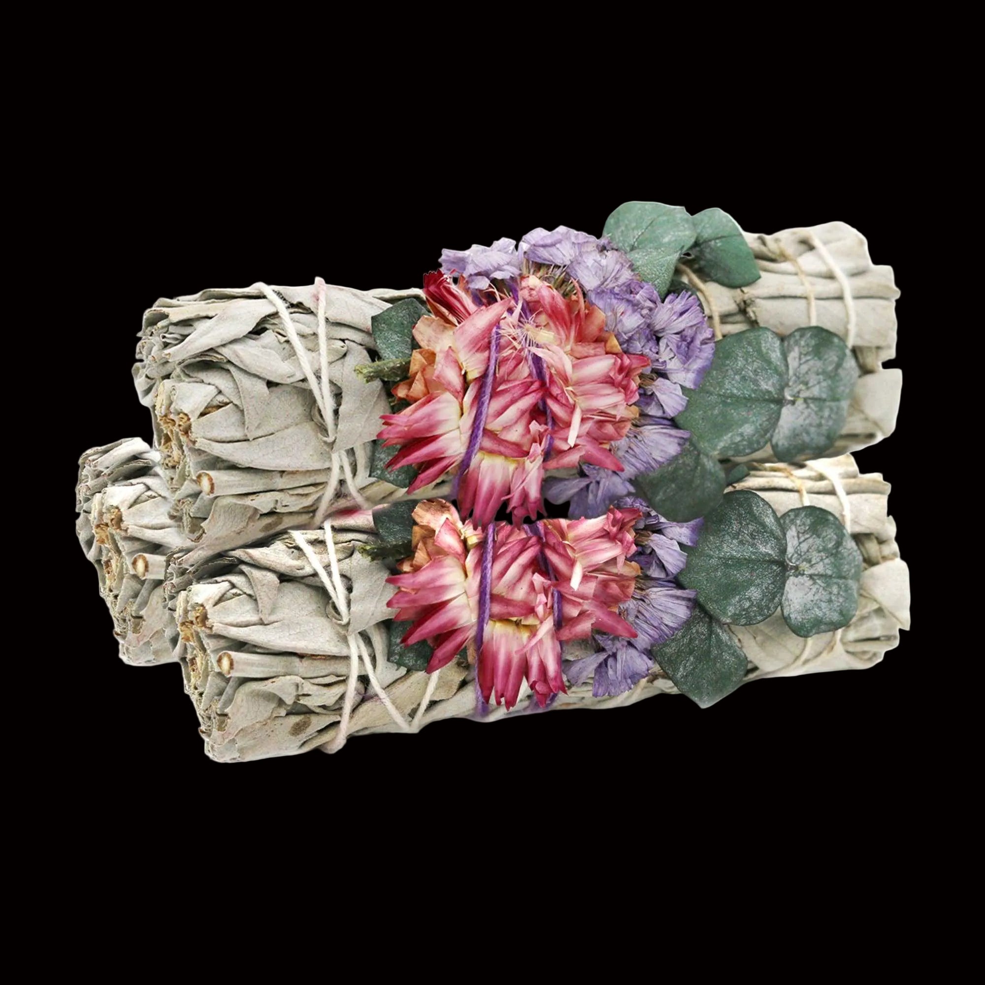 Three bundles of sage with flowers and leaves on a white background