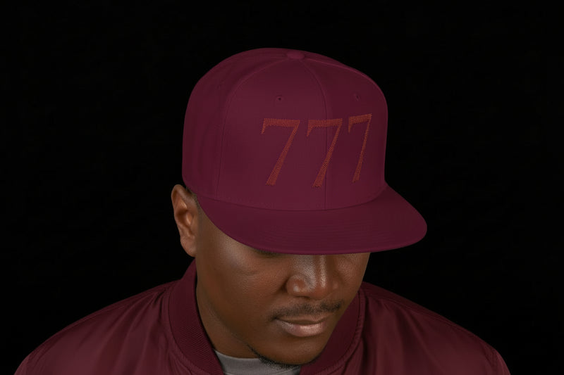 Man wearing a maroon cap with '777' on a white background