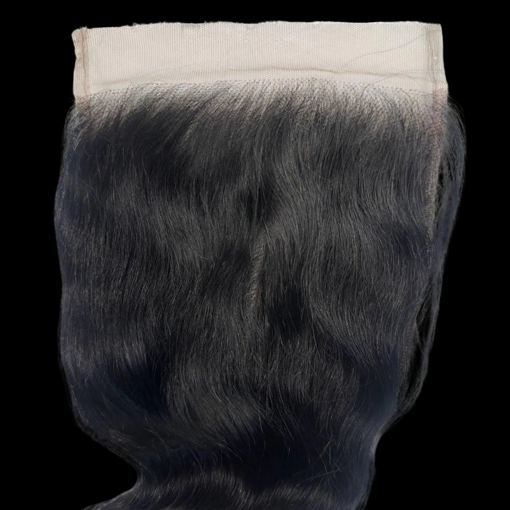 Black hair extension with a beige clip on a white background