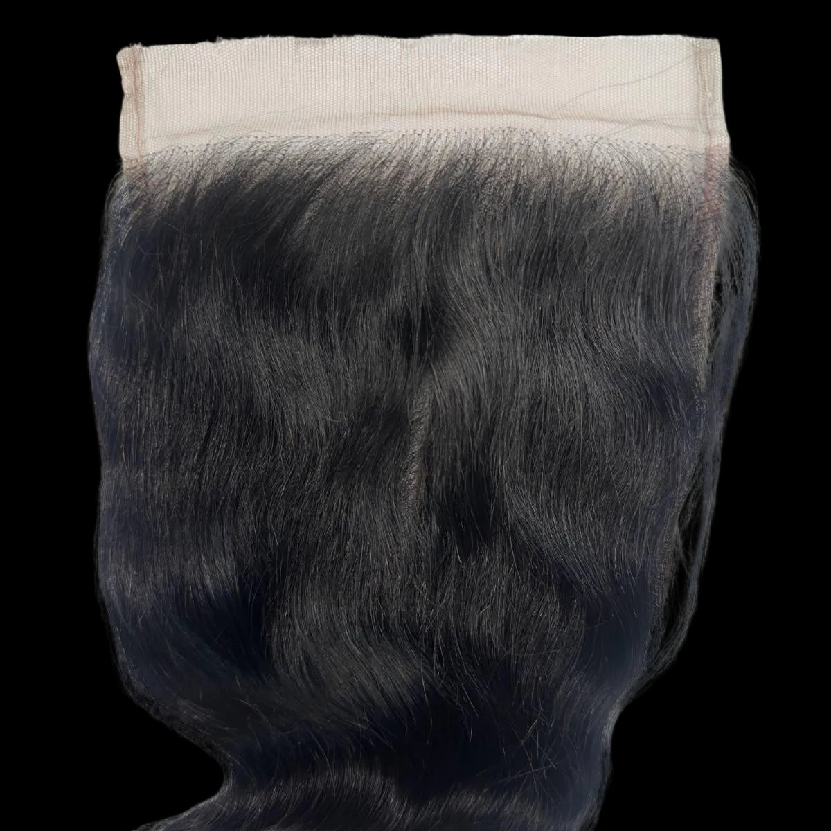 Black hair extension with a beige clip on a white background