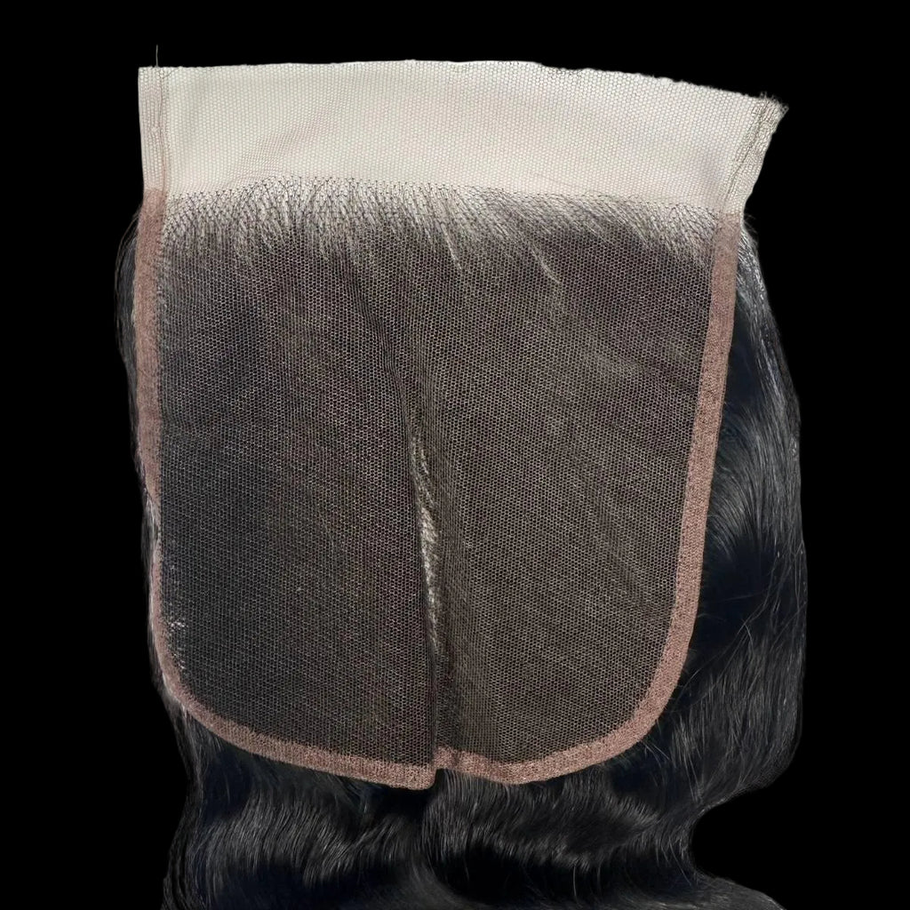 Close-up of a hair wig with a brown mesh back on a white background