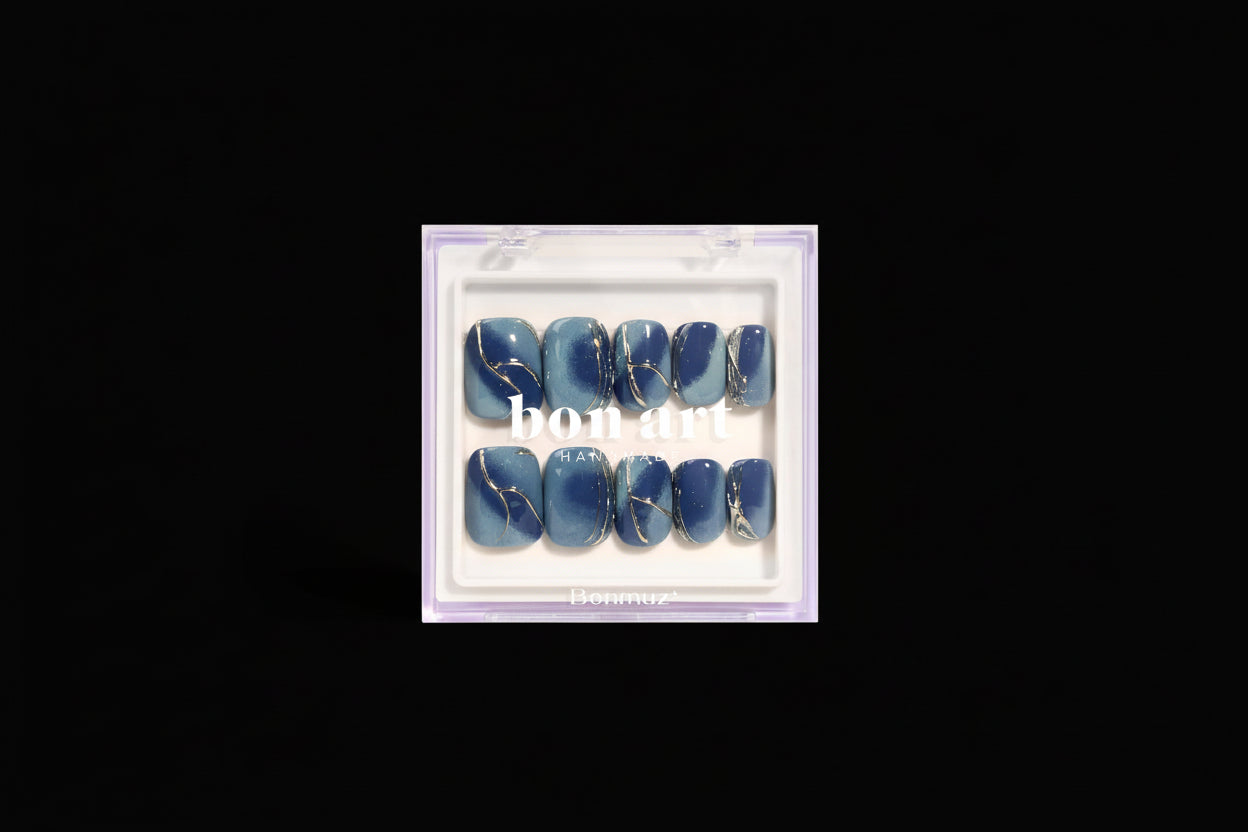 Set of blue nail art designs in a clear plastic case with 'bon art' branding.