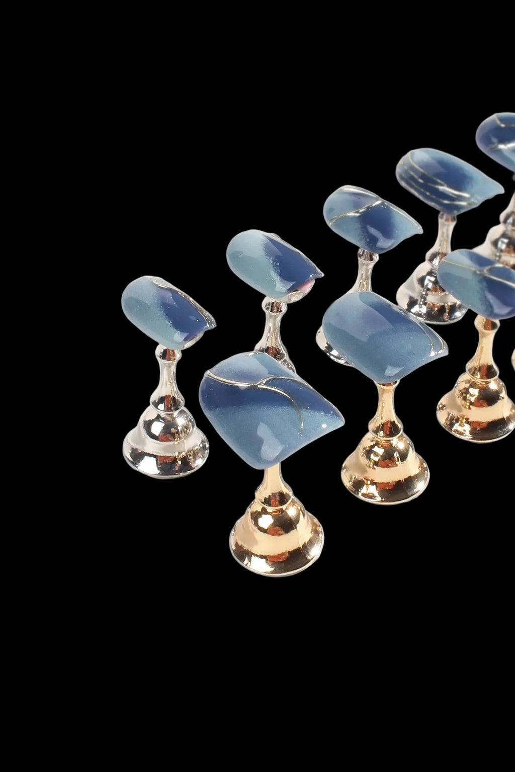 Blue gemstone earrings with gold accents on a white background