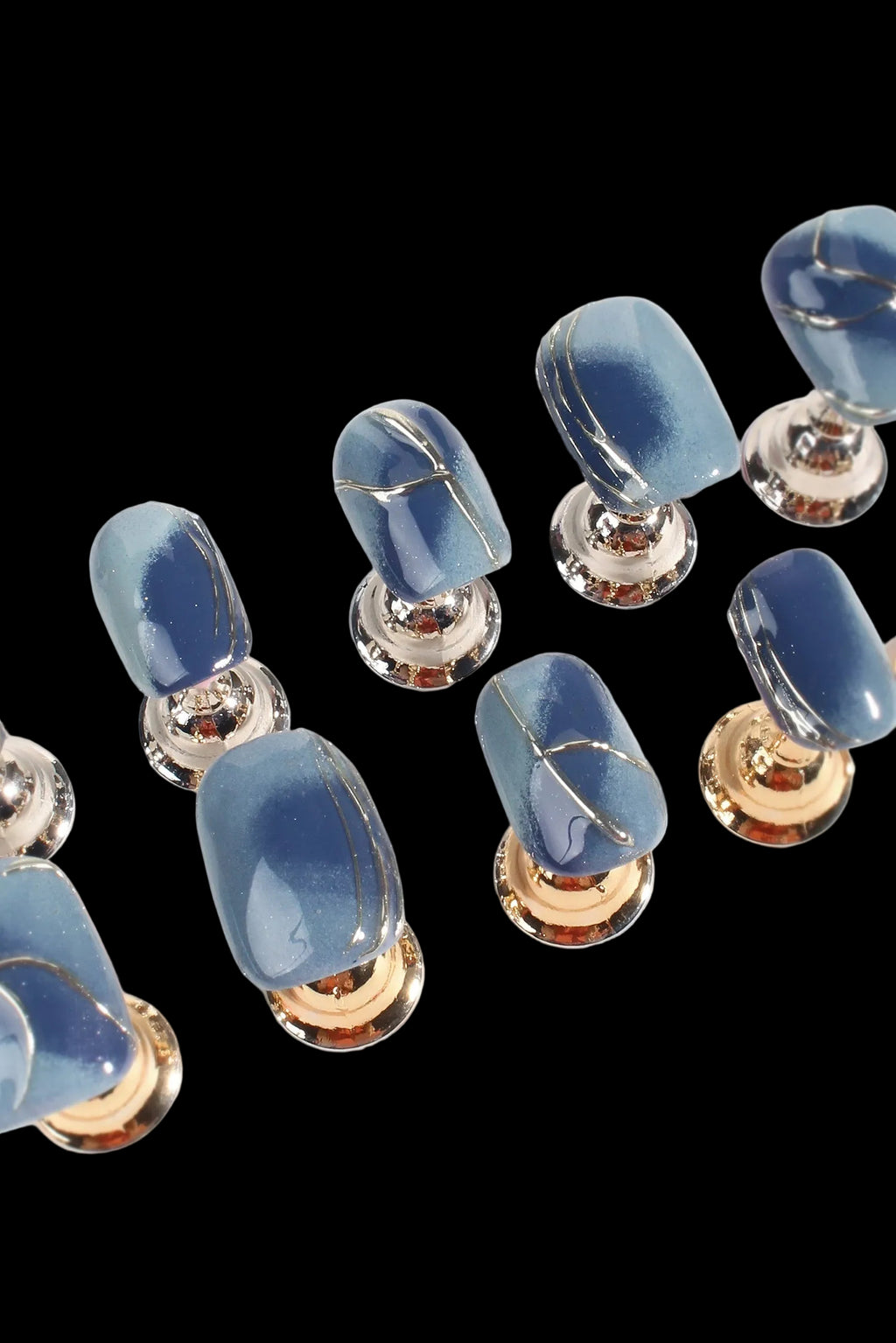 Blue stone buttons with gold and silver metal bases on a white background