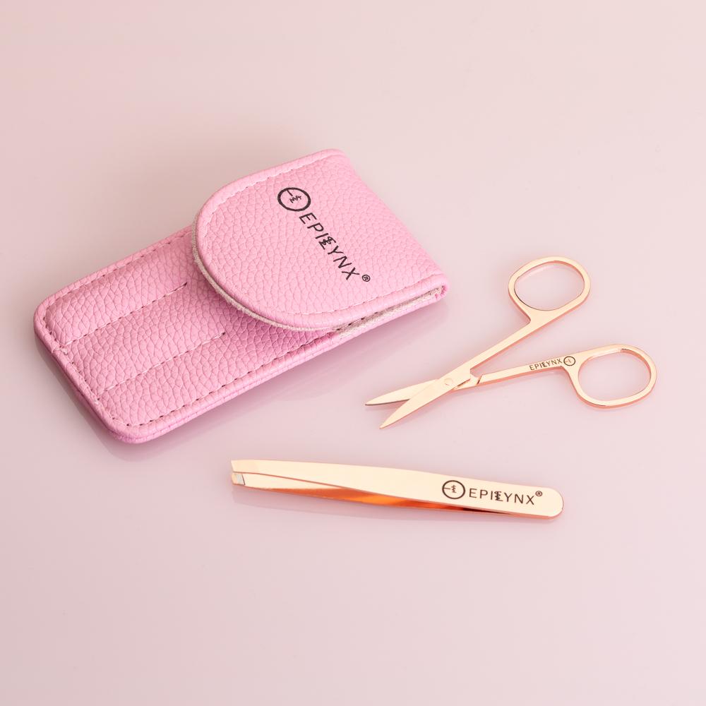 Rose gold scissors and tweezers with pink case on a light pink background, featuring the Epibynx brand.