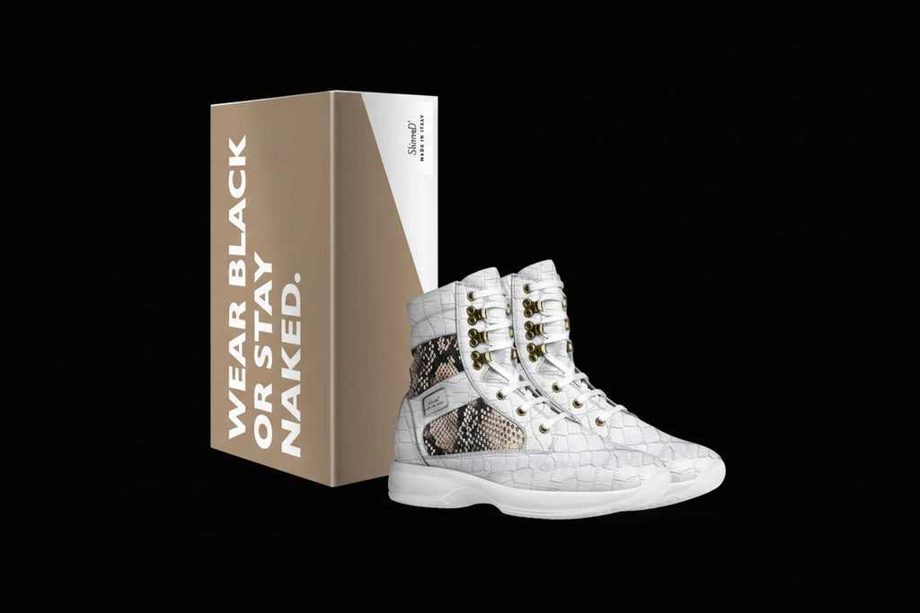 White high-top sneakers with snake skin pattern and gold accents next to a branded box on a white background.