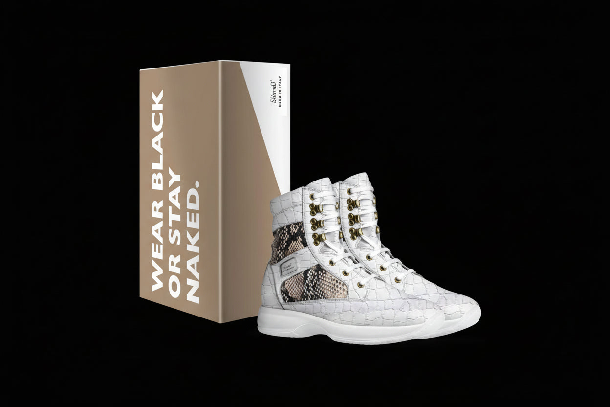 White high-top sneakers with snake skin pattern and gold accents next to a branded box on a white background.