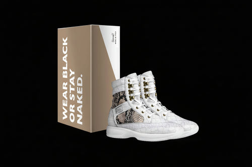 White high-top sneakers with snake skin pattern and gold accents next to a branded box on a white background.