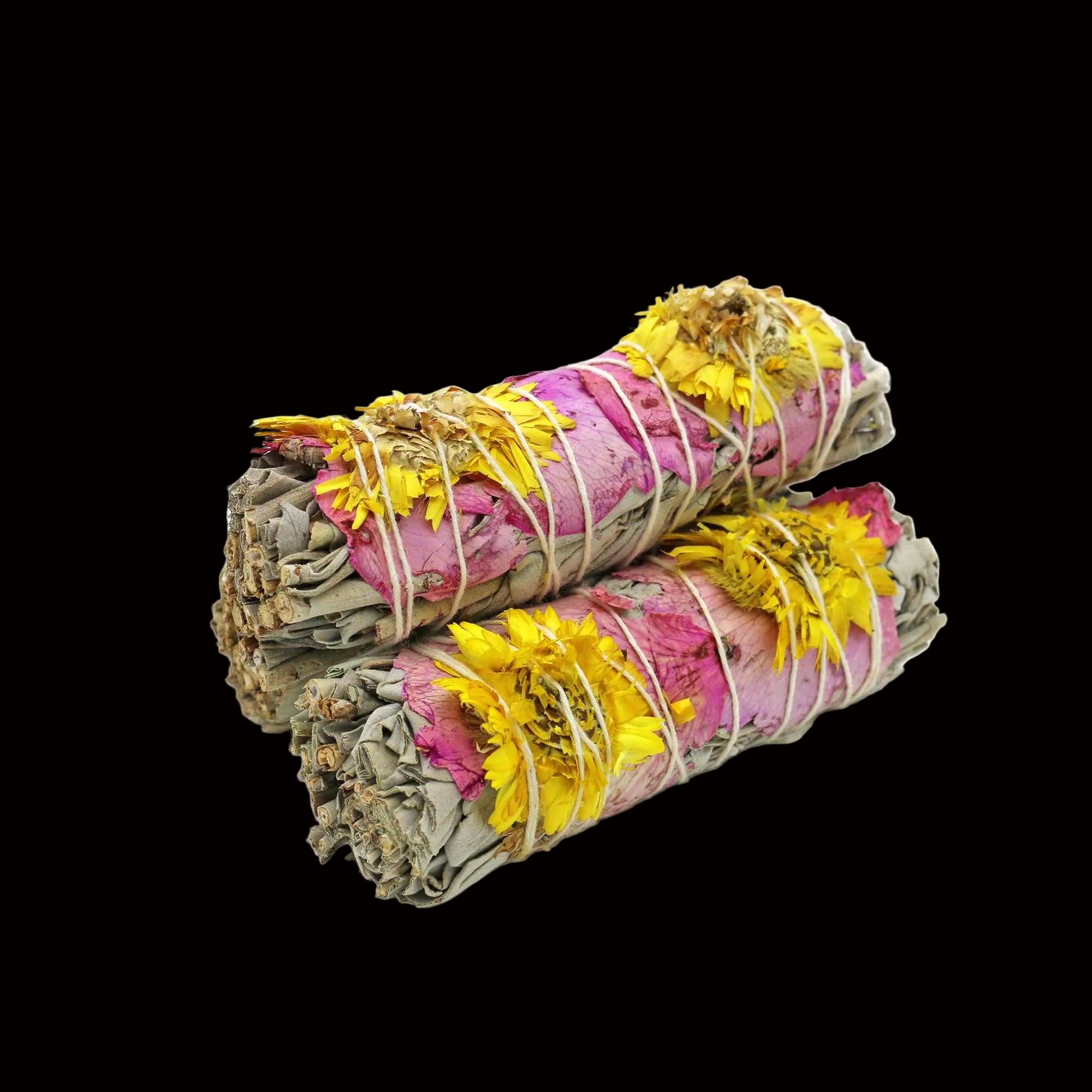 Two bundles of incense sticks with pink and yellow flowers on a white background