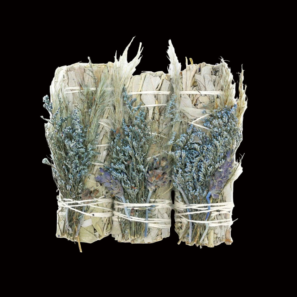 Bouquet of dried herbs tied with twine on a white background