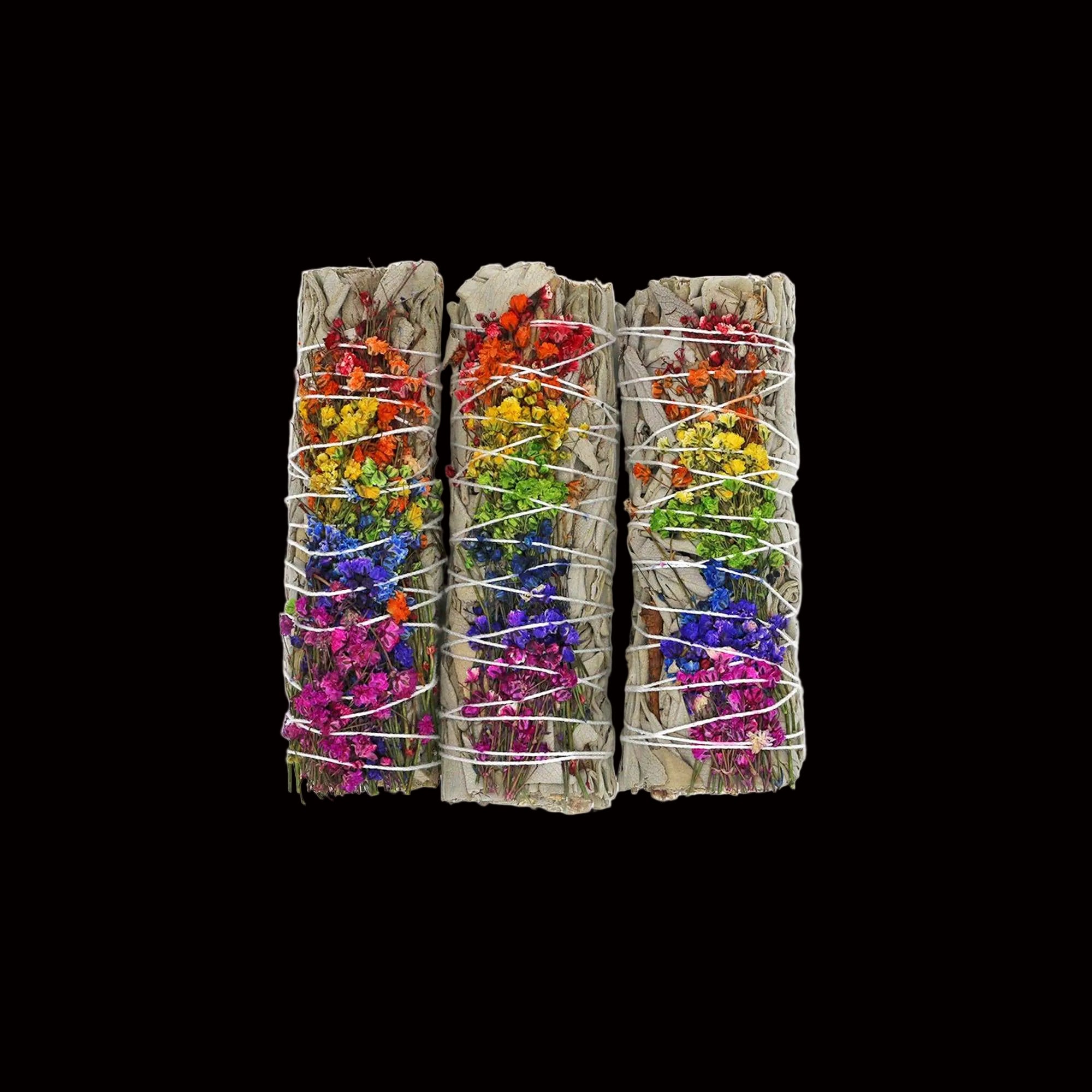 Three bundles of colorful flowers tied together on a white background