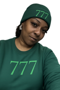 Person wearing a green beanie and shirt with '777' print on a white background
