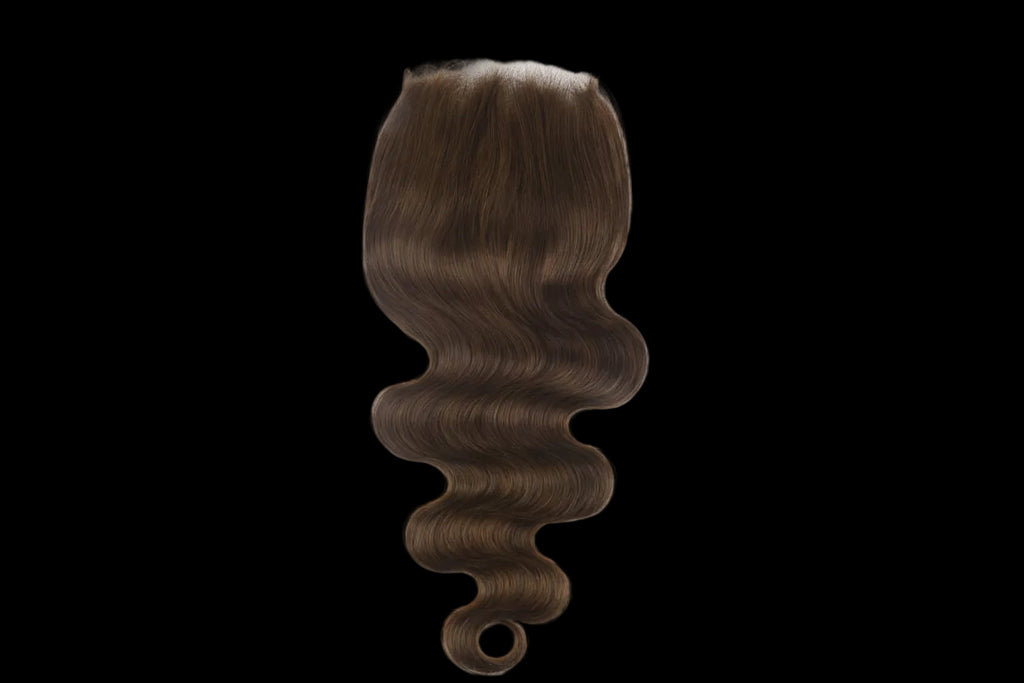 Brown hair extension with a white base on a white background