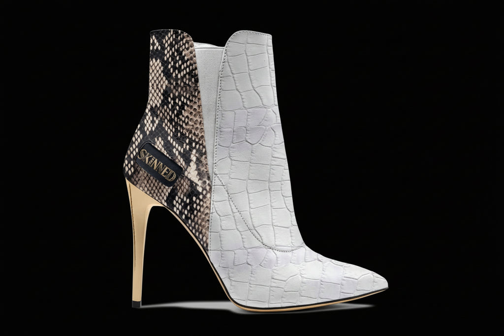 High-heeled ankle boots with snake print and crocodile texture on a white background