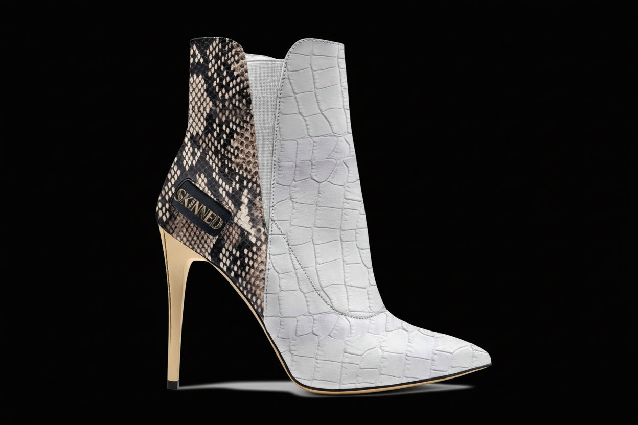 High-heeled ankle boots with snake print and crocodile texture on a white background