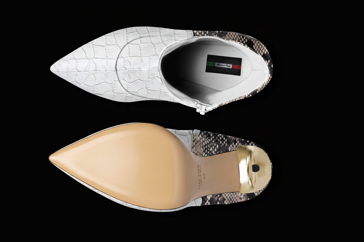 Close-up of a pointed-toe shoe with white and beige soles on a white background