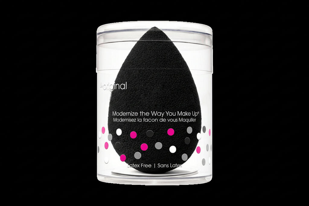 Black makeup sponge in a clear container with text on a white background