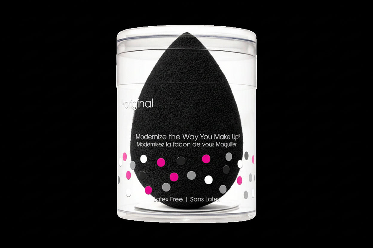Black makeup sponge in a clear container with text on a white background