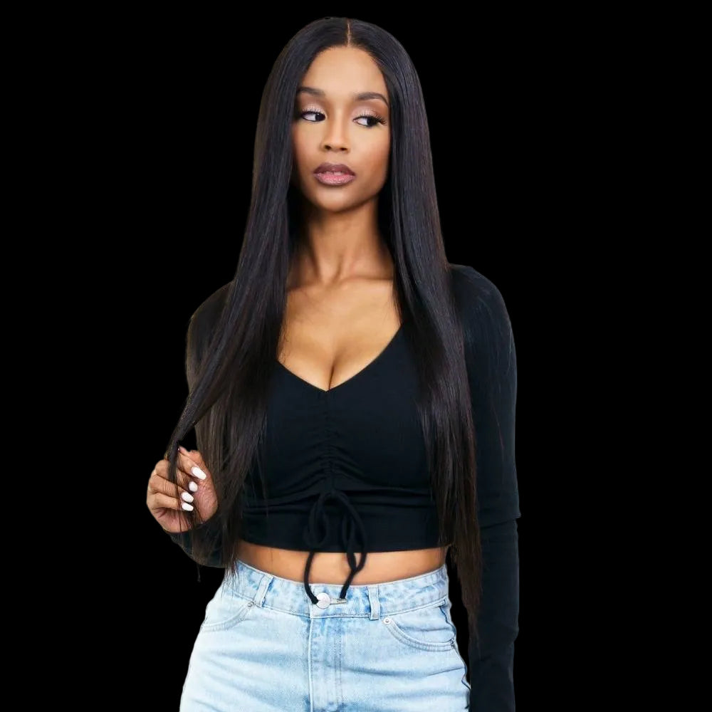 Woman with long black hair wearing a black top and light blue jeans on a white background