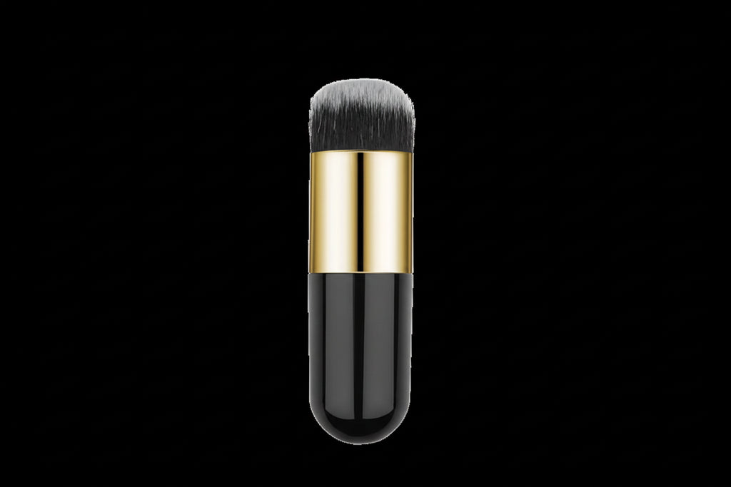 Makeup brush with black and gold handle on a white background
